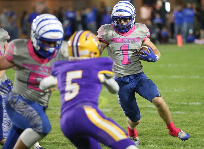 Princeton's Casey Etheridge runs the ball as teammate Brennen Emmett blocks Mendota's Gavin Stevenson from making a tackle on Friday, Oct. 10, 2025 at Bryant Field in Princeton.