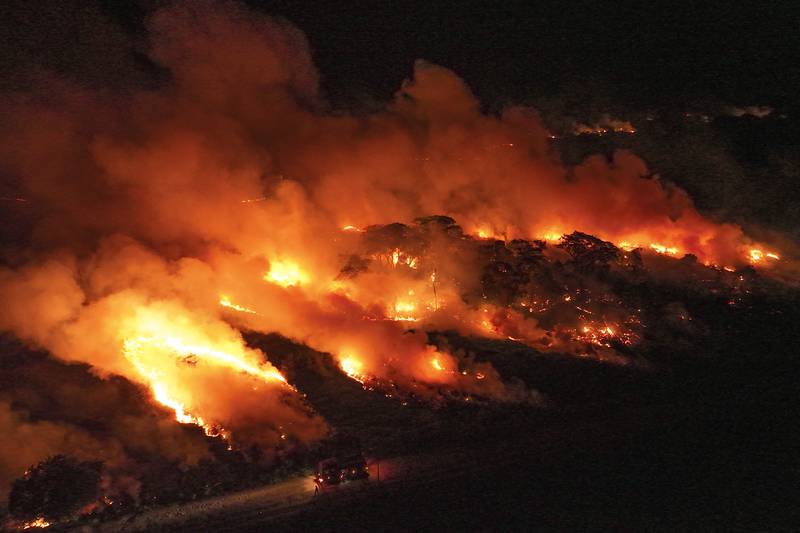 FILE - Fire consumes an area next to the Transpantaneira road in the Pantanal wetlands near Pocone, Mato Grosso state,Brazil, Nov. 15, 2023. (AP Photo/Andre Penner, File)