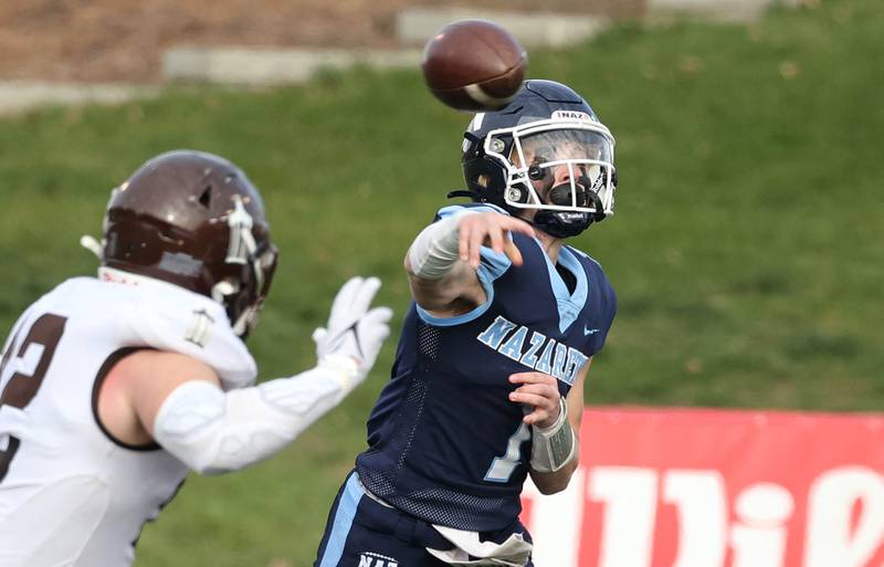 Nazareth's Logan Malachuk makes a throw as Joliet Catholic players drop into coverage Saturday, Nov. 25, 2023, during their IHSA Class 5A state championship game in Hancock Stadium at Illinois State University in Normal.