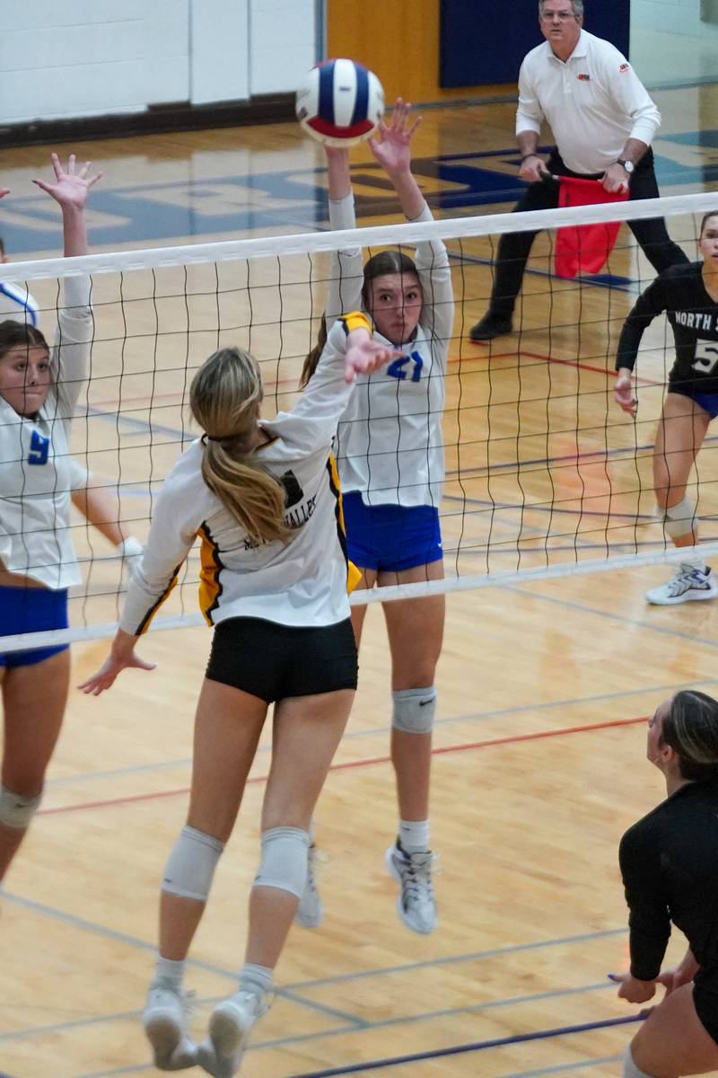 St. Charles North's Brynn Hopkins (21) defends the net against Metea Valley's Maddie Hopkins (11) during a Class 4A West Aurora Sectional semifinal volleyball match at West Aurora High School on Tuesday, Nov. 5, 2024.