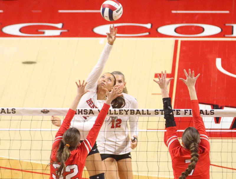 Benet's Gabby Stasys tips the ball past Huntley's Izzy Whitehouse and teammate Jocelyn Erling during the Class 4A State semifinal game on Friday, Nov. 15, 2024 at CEFCU Arena in Normal.