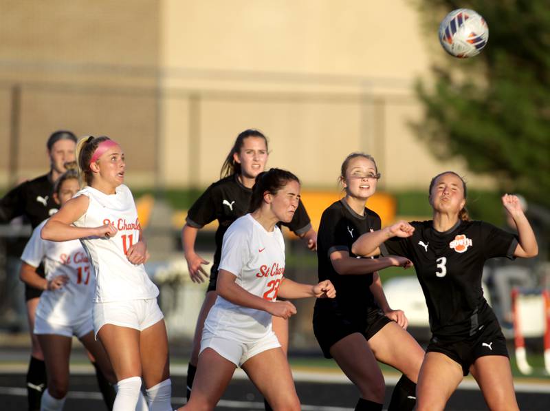 St. Charles East and Wheaton Warrenville South players go after a corner kick during a game in Wheaton on Tuesday, April 18, 2023.