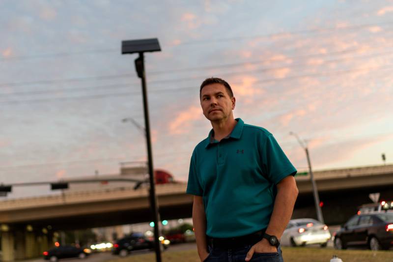 Alek Schott stands next to a Flock Safety license plate reader in his neighborhood, Thursday, Oct. 16, 2025, in Houston. (AP Photo/David Goldman)