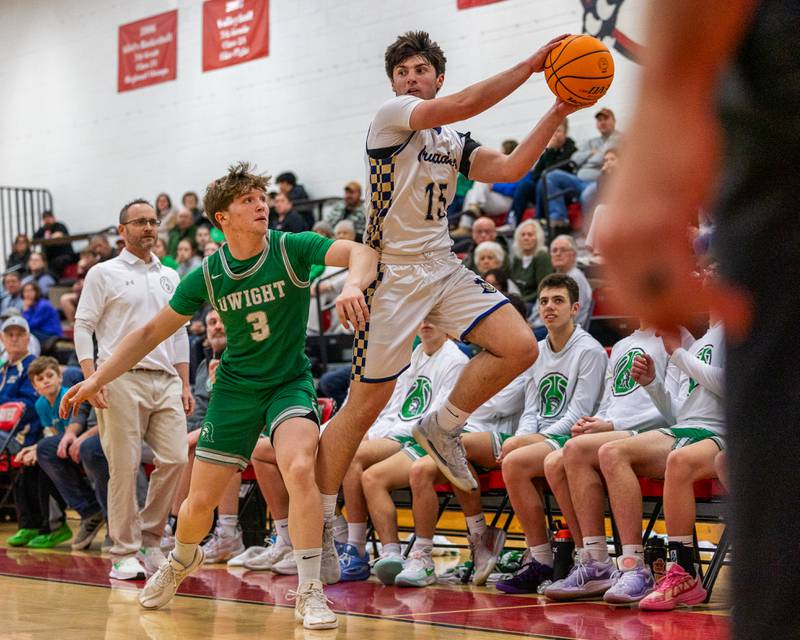 Marquette's Alec Novotney (15) leaps to save ball before it falls out of bounds as Collin Bachand (3) of Dwight guards at hip on Saturday, Feb. 21, 2026 at Marseilles Elementary School.