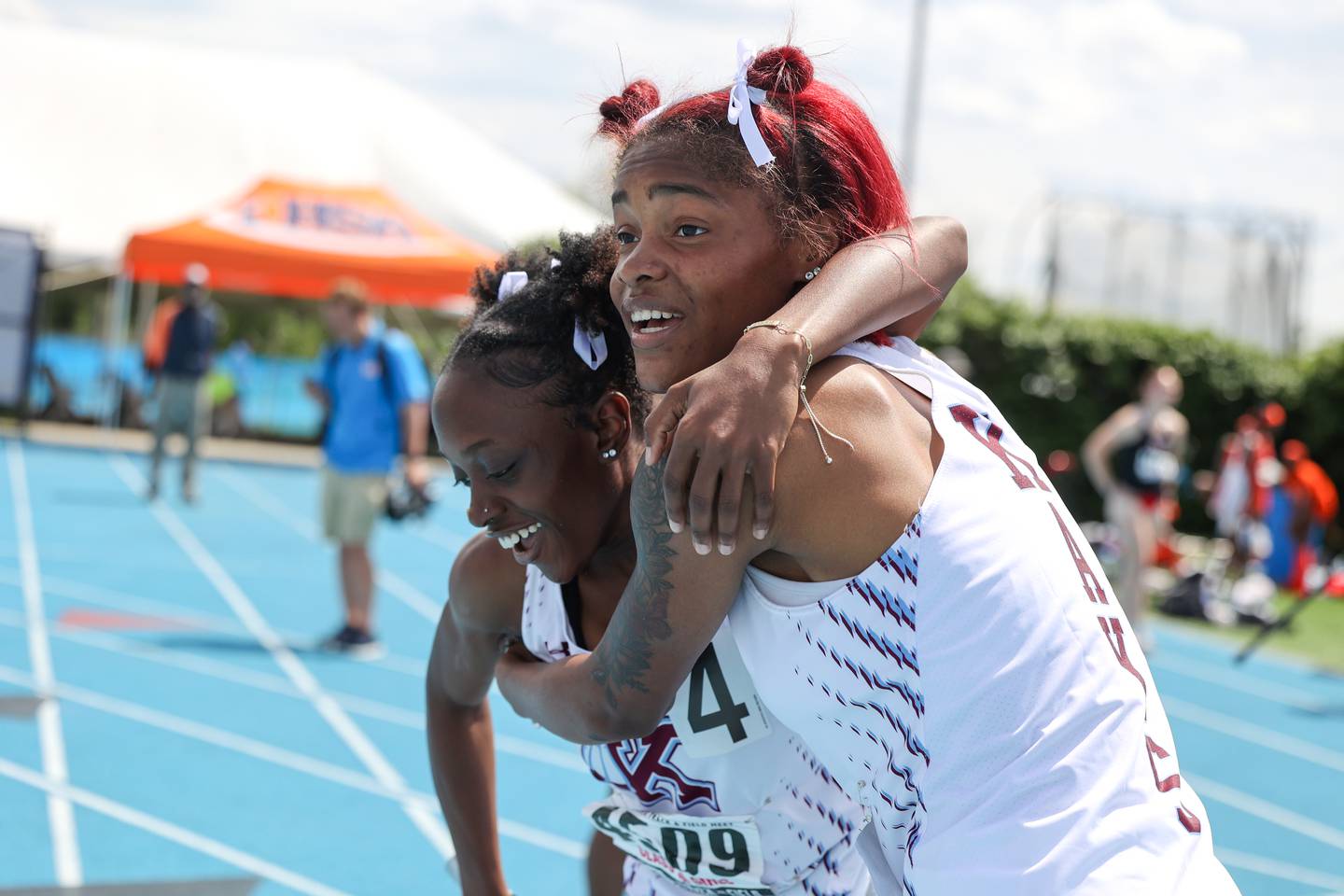 Kankakee’s Trinity Noble hugs teammate Essence Bell after the Kays secured second place in the 4x200 relay during the IHSA Class 3A Girls Track & Field State Finals on Saturday, May 24, 2025.