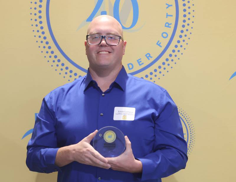 Brandon LaChance poses with his 40 Under Forty award during the Illinois Valley Chamber of Commerce Champions of Change Awards Night on Wednesday, May 6, 2026 at the Westclox Event Center in Peru.