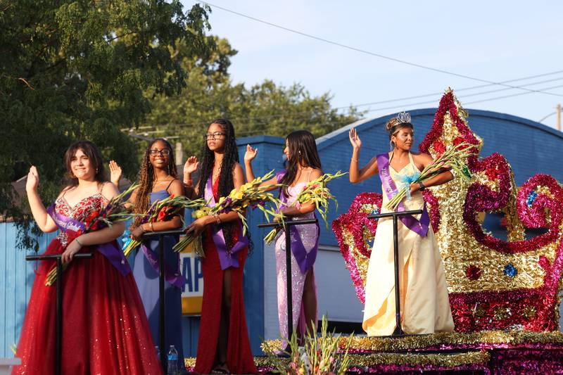 Jennifer Corona, right, the 2025 Gladiolus Festival queen, waves to the crowd alongside fellow court participants during the 87th Momence Gladiolus Festival Main Street Parade on Friday, Aug. 8, 2025.