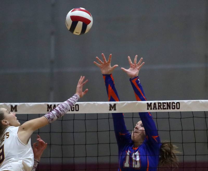 Genoa-Kingston’s Bria Botterman, right, and Richmond-Burton’s Dani Hopp battle at the net in IHSA Class 2A Regional Title Game volleyball action on Thursday, Oct. 31, 2024, at  Marengo High School  in Marengo.