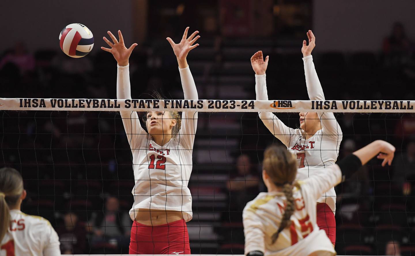 Benet’s Lynney Tarnow and Audrey Asleson, right, watch a point get past them from Mother McAuley’s Abbey Williams in the Class 4A girls volleyball state championship match at Illinois State University in Normal on Saturday, October 11, 2023.