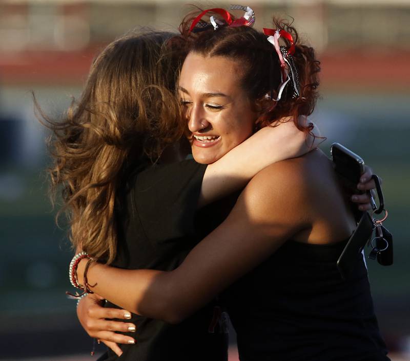 Huntley’s Sophie Amin receives a hug after she won the 100 meter hurdles during the Huntley IHSA Class 3A Girls Sectional Track and Field Meet on Wednesday, May 8, 2024, at Huntley High School.