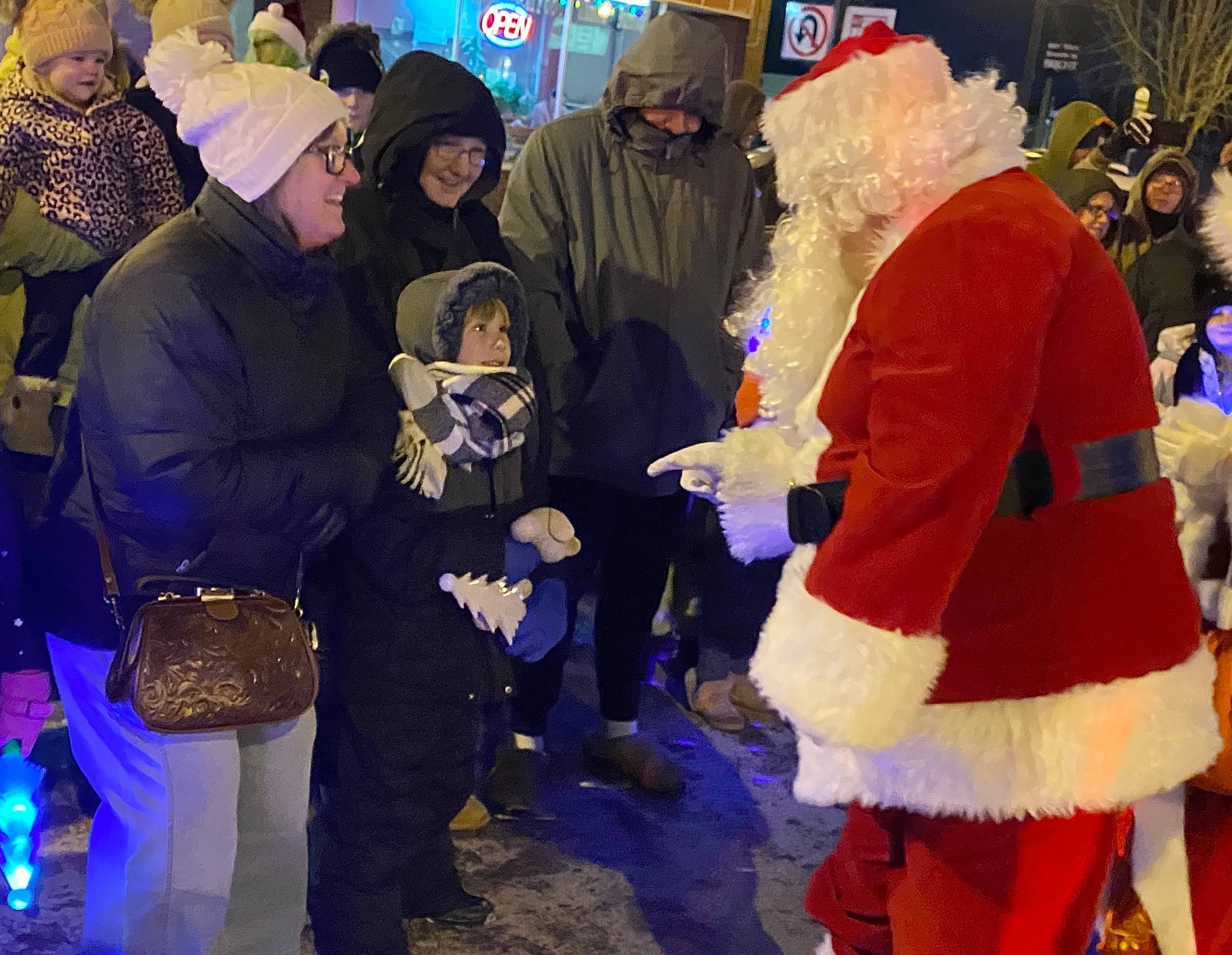Santa Claus greets waiting children eager to tell him what they want for Christmas on Friday, Dec. 5, 2025, at the Sycamore Chamber of Commerce's annual Walk with Santa in downtown Sycamore.