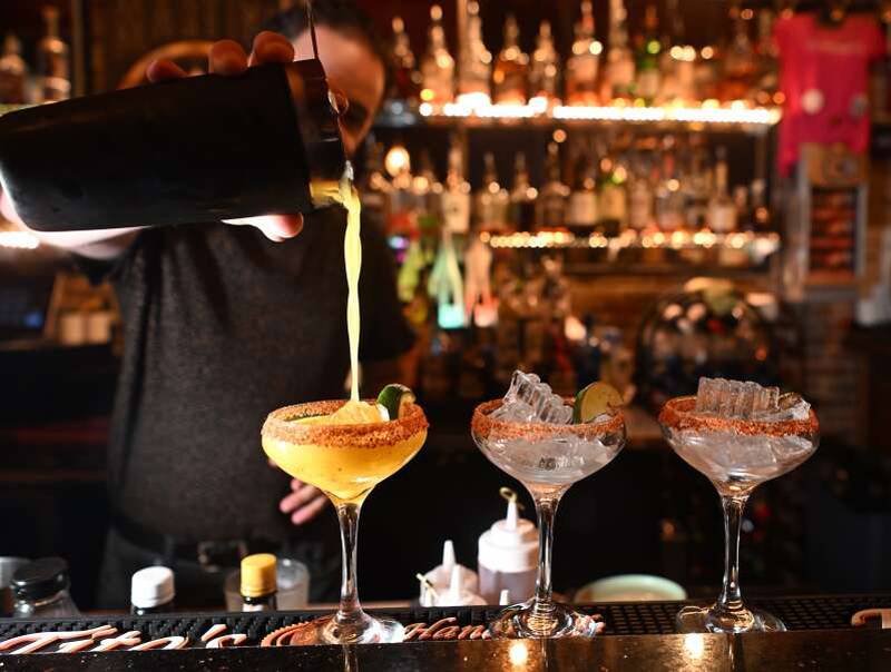 Dave Olinger pours a drink at The Martini Room in Elgin. The bar is celebrating 20 years in business.