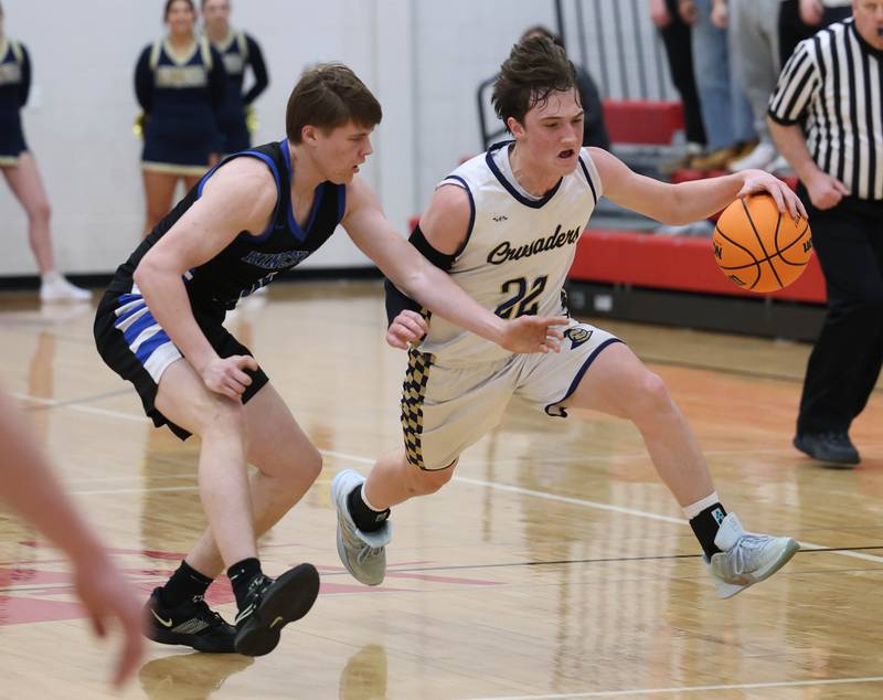 Marquette's Griffin Dobberstein pushes the ball upcourt against Hinckley-Big Rock's Judah Miceli Tuesday, March 3, 2026, during their sectional semifinal matchup at Amboy High School.