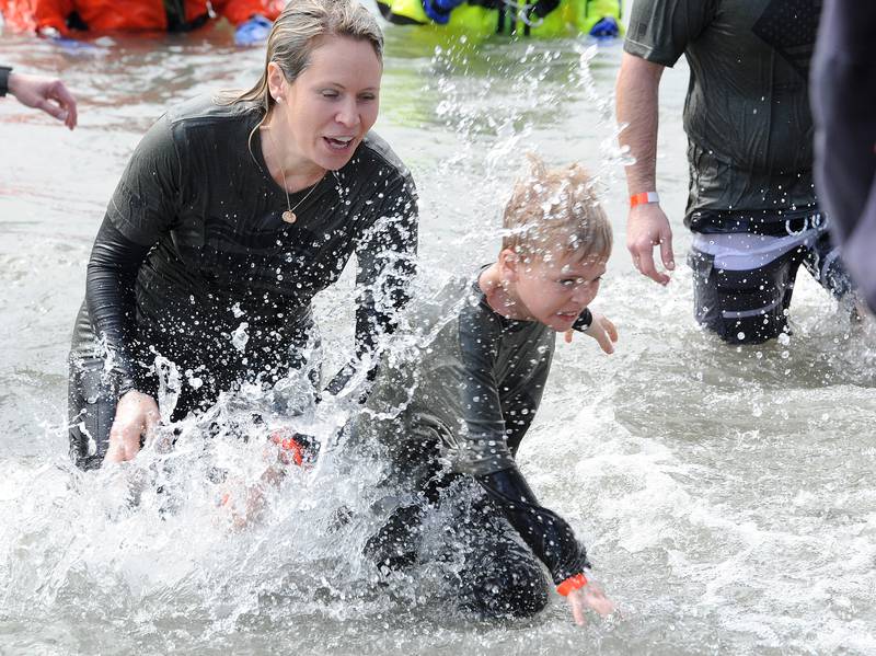 Representing the Glen Ellyn Police Department, Kerri splashes her son Mason with cold water during the annual Polar Plunge to support Special Olympics Illinois at Siver Springs State Park's Loon Lake on Sunday, Mar. 5, 2023.