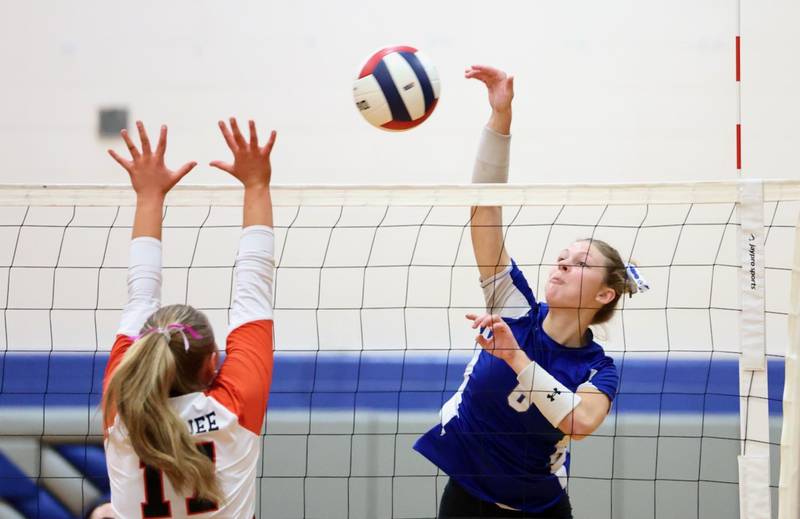 Princeton's Caroline Keutzer hits over Kewanee's Macee Pickering (17) in Tuesday's regional semifinal match at Princeton. The Tigresses won 2-0 to advance to Thursday's finals against Newman.