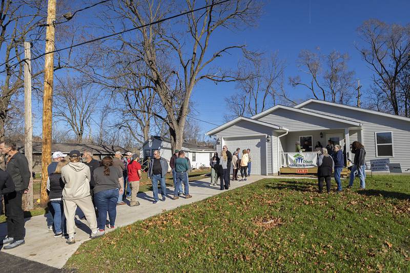 Volunteers and supporters for Dixon Habitat for Humanity gather outside of the 33rd built house Sunday, Nov. 23, 2025, after the blessing.