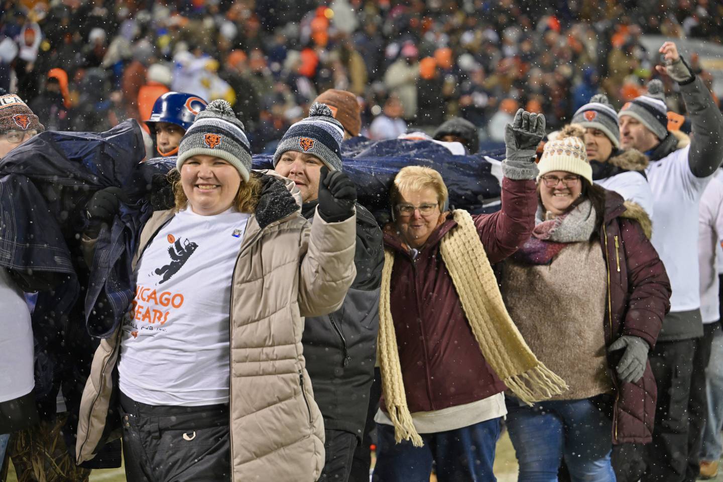 Ashley Vilona, Advocate Health Care’s 2025 Nurse Leader of the Year, and Lea Good, Advocate Health Care’s 2025 Nurse of the Year, helped unfurl the giant flag during pregame introductions for the Bears’ playoff matchup against the Los Angeles Rams.