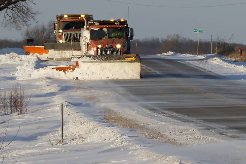 Snowplows push drifting snow off Greenwood Road near the intersection of Norgard Road on Thursday, Jan. 22, 2026.
