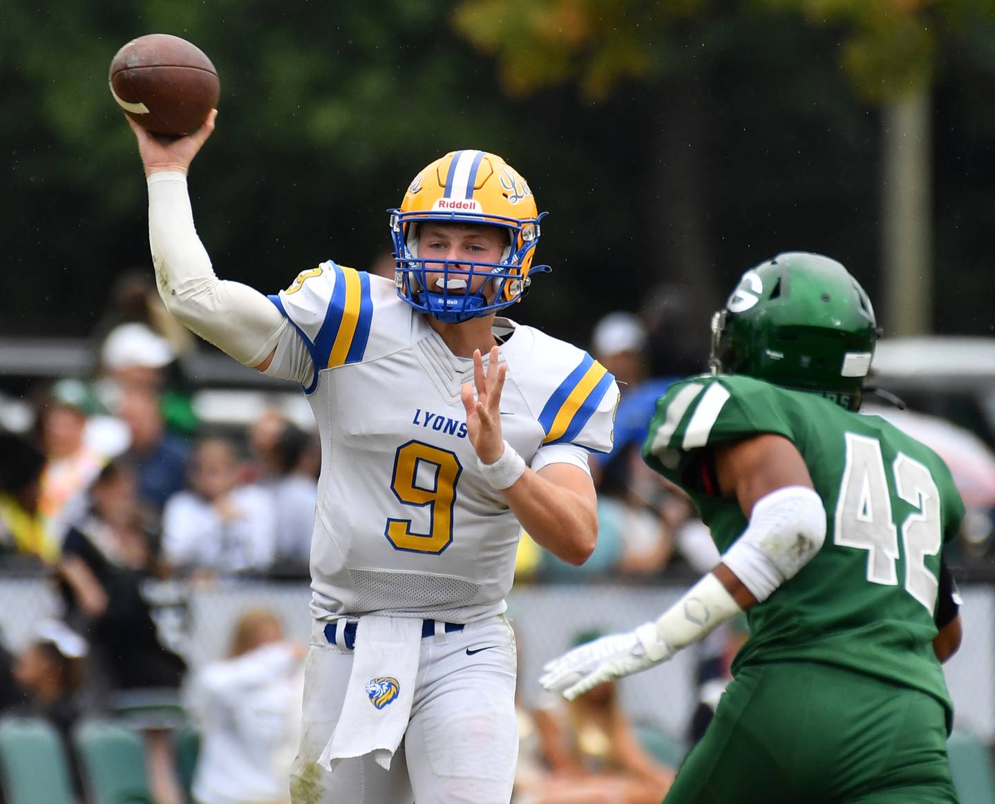 Lyons Township quarterback Ryan Jackson fires a pass as Glenbard West's Val Jones pressures during a game on Sep. 16, 2023 at Glenbard West High School in Glen Ellyn.