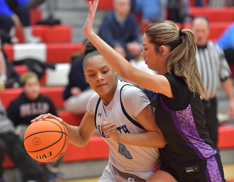 Nazareth’s Mia Gage (4) drives as Downers Grove North’s Eva Yerkovich defends during the Class 4A Hinsdale Central Sectional final game on February 26, 2026 at Hinsdale Central High School in Hinsdale.