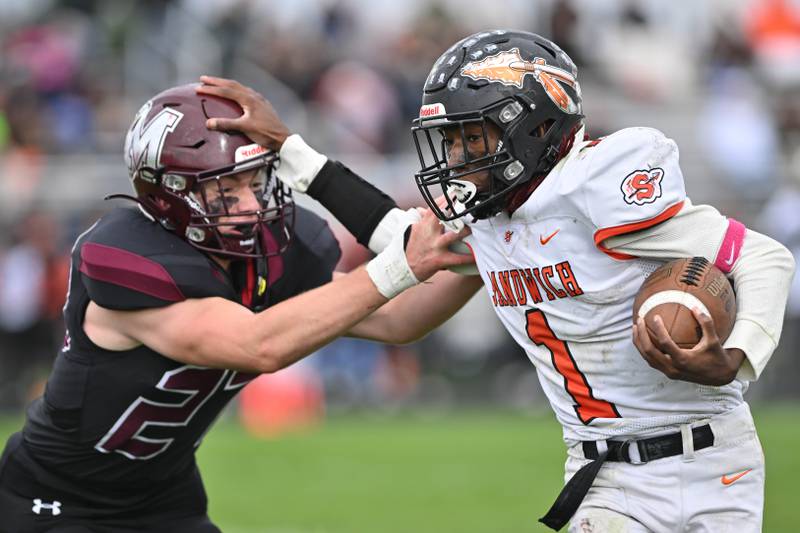 Sandwich's Simeion Harris attempts to avoid a tackle from Marengo's Rylan Smith during their 2023 Kishwaukee River Conference game in Marengo.