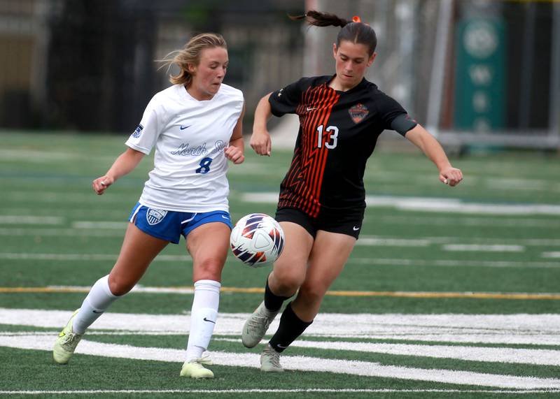 St. Charles North's Keira Kelly (left) and St. Charles East's Georggia Desario go after the ball during a Class 3A Glenbard West Sectional semifinal game on Tuesday, May 27, 2025 in Glen Ellyn.