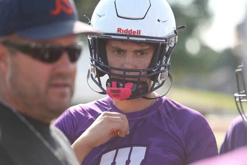 Wilmington’s Brendan Moran listens to coach Jeff Reents before the start of the Morris 7 on 7 scrimmage. Tuesday, July 19, 2022 in Morris.