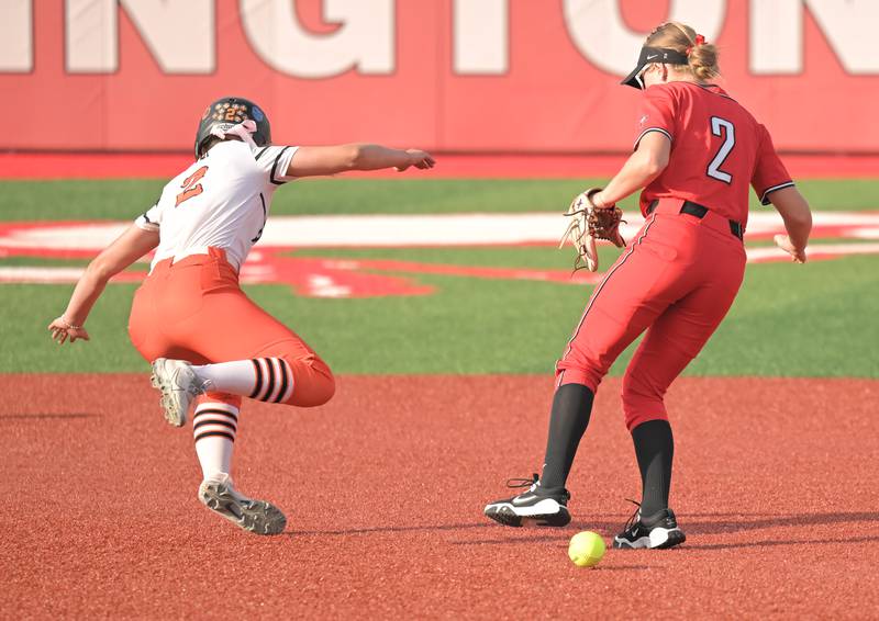 St. Charles East’s Addison Wolf falls to the turf after colliding with Barrington second baseman Shaylee Hiser as she advanced on a ground ball by teammate Lexi Majkszak in an IHSA Class 4A supersectional softball game in Barrington on Monday, May 9, 2025. Wolf was called out for interference in the first inning.