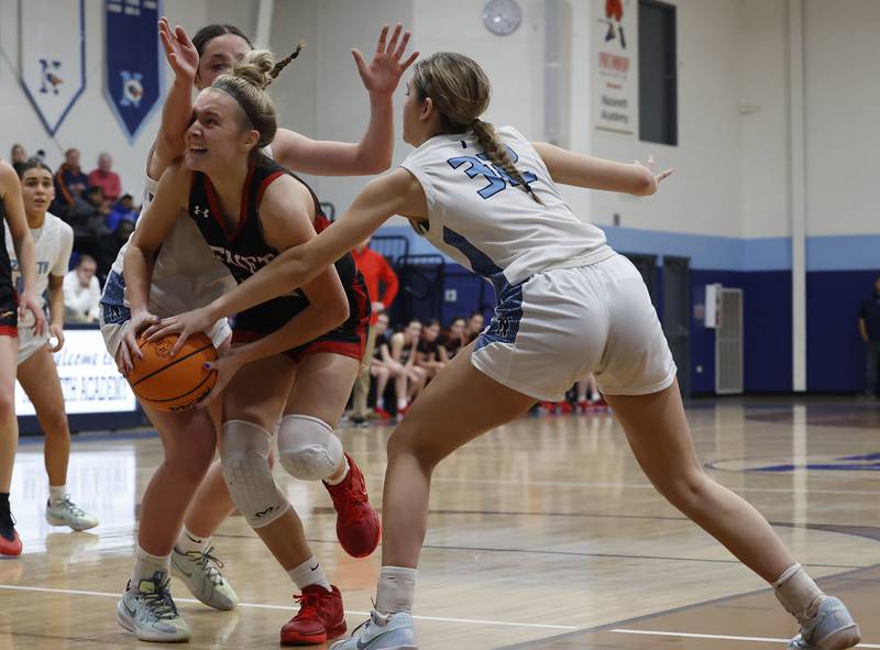Benet's Bridget Rifenburg (22) tries to get past the Nazareth defense during a girls varsity basketball game between Benet and Nazareth academies on Saturday, Dec. 14, 2024 in La Grange Park.