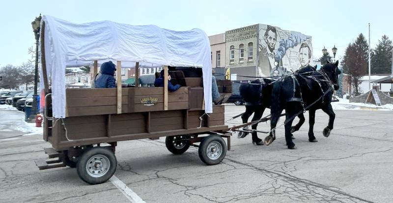 Polo's Christmas Festival included Mane Street Horse and Wagon Rides on Saturday, Dec. 6, 2025. Here, one of the wagons crosses Mason Street.