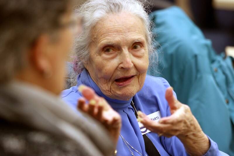 Marti Swanson of Ringwood visits with others during a meeting of the McHenry County Illinois Genealogical Society on Thursday, March, 9, at McHenry County College. Thursday was the group’s first in-person meeting since before the pandemic.