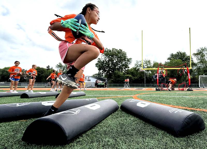 Kayla Alva runs through a drill during the Chicago Bears Mini Monsters Flag Football Camp on Wednesday, July 16, 2025. at McCracken Field in McHenry.