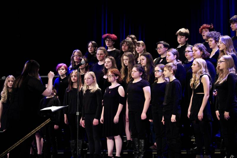 Ashley Almquist directs the Reagan Middle School Choir during its rendition of "Listen to the Rain" on Friday, March 3, 2023, at Wiltz Auditorium.