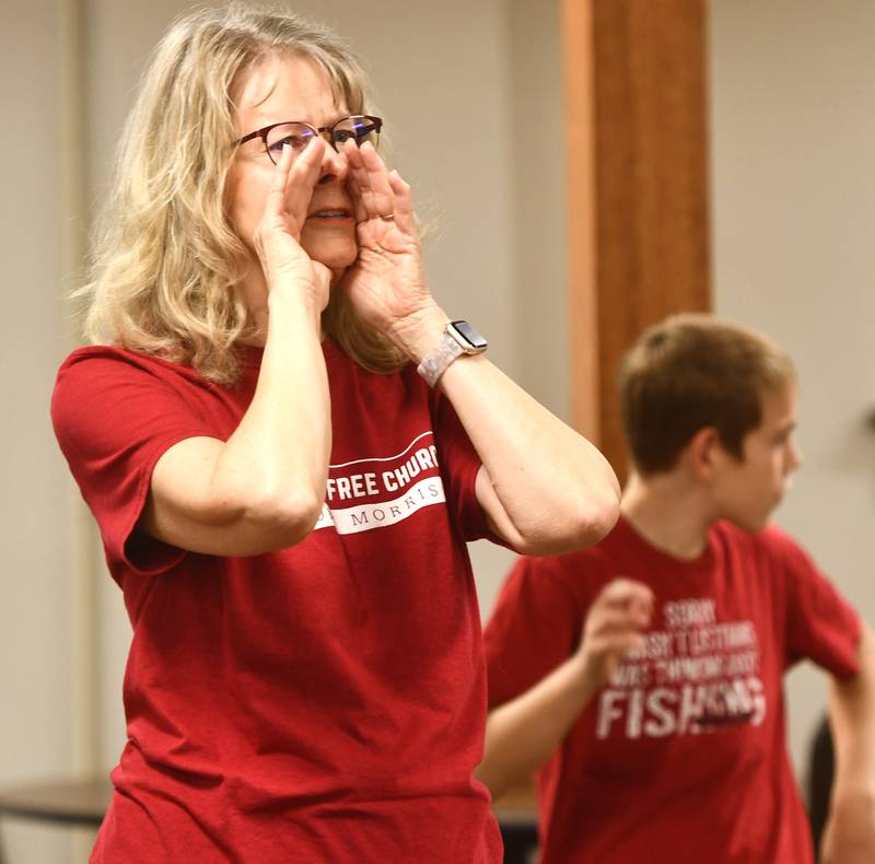 Joyce Long, chairman of the Outreach Team for the Evangelical Free Church of Mt. Morris, directs volunteers on Thursday, Oct. 16, 2025 as they assemble care packages for sailors serving on the USS Fitzgerald.