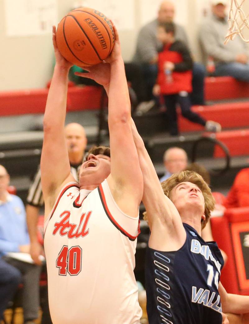 Hall's Payton Dye grabs a rebound over Bureau Valley's Justin Moon on Tuesday, Feb. 6, 2024 at Hall High School.