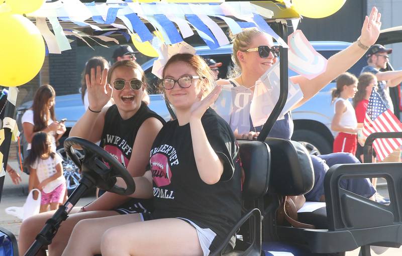 Hall High School yearbook students ride during the Homecoming parade on Thursday, Sept. 18, 2025 downtown Spring Valley.