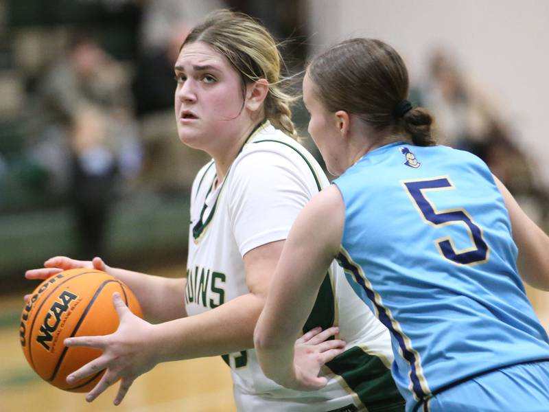 St. Bede's Savannah Bray eyes the hoop as Marquette's Chloe Larson defends on Monday, Dec. 2, 2024 at St. Bede Academy.