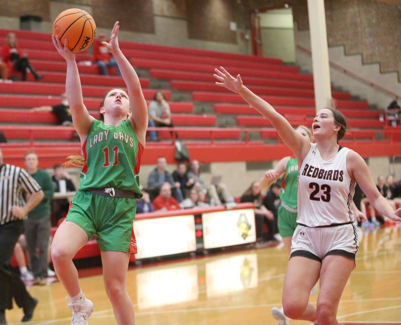 L-P's Elizabeth Sines runs in for a layup over Metamora's Kessa Sell during the Ottawa Girls Holiday Tournament on Monday, Dec. 16, 2024 in Kingman Gym at Ottawa High School.