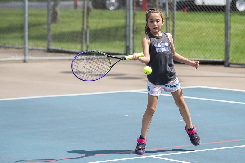 Parker Brigl returns a shot while playing in the 11 and under girls singles at the Emma Hubbs tennis classic Thursday, July 26, 2022.