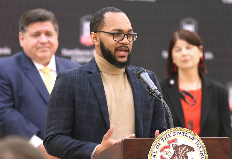 Northern Illinois University student Devlin Collins speaks as Illinois Gov. JB Pritzker looks on Thursday, March 3, 2022, in the Barsema Alumni and Visitors Center at NIU in DeKalb. Pritzker was visiting NIU to talk about the importance of higher education and to tout the programs in Illinois that make that education more accessible to all.