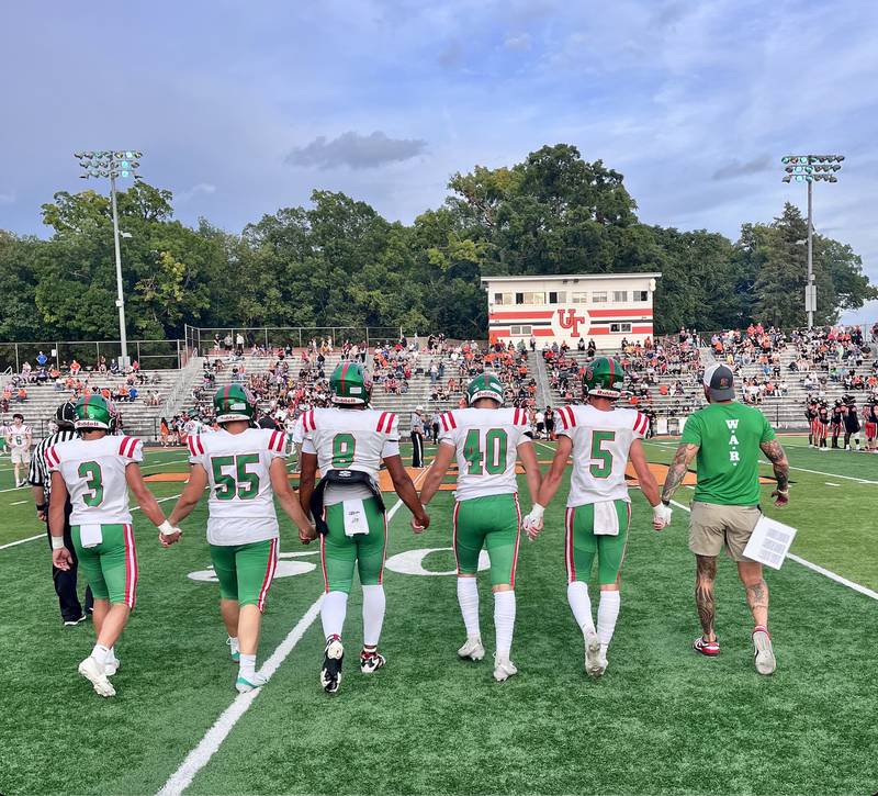 L-P players (from left) Rylynd Rynkewicz, Gus Konieczki, Marion Persich, Nick Hachenberger and Regan Doerr along with coach JJ Raffelson walk to midfield for the coin toss before Friday's game at United Township. The game was postponed to 1 p.m. Saturday due to inclement weather. The Cavaliers trailed 16-15 with 9:44 left in the second quarter when the game was stopped.