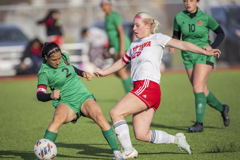 Vicky Tejada of LaSalle-Peru High School looks for an opening against the defense of Taylor Brandt of Ottawa High School during the match on April 10, 2025 at the LaSalle-Peru Sports Complex.
