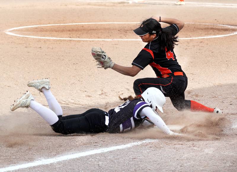 Dixon’s Breanna Tegeler slides in safely to third as DeKalb's Isabel Aranda applies the tag Thursday, May 22, 2025, during their game at DeKalb High School.