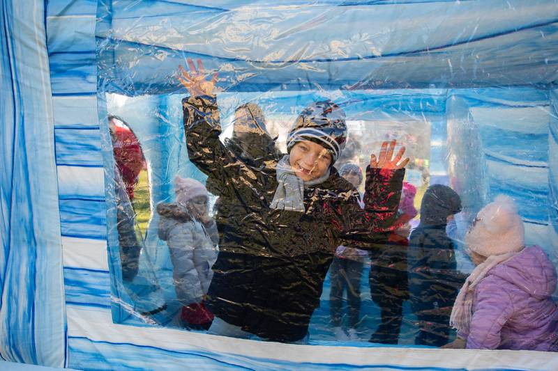 Sebastian Kozlowski, of Willow Springs, has fun in the Giant Snow Globe at Christmas in the Square in Lockport on Saturday, Nov. 25, 2023.