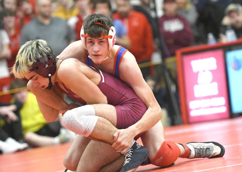 Oregon's Lane Halverson looks to his coaches as he wrestles Dakota's Jason Bowers in the consolation semifinal on Saturday at the 1A Oregon Sectional on Saturday. Bowers won the match eliminating Halverson from moving on to the state finals. Bowers finished third.