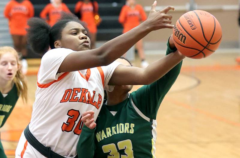 DeKalb's Cayla Evans and Waubonsie Valley's Aalyiah Aranda go after a loose ball during their game Thursday, Dec. 15, 2022, at DeKalb High School.