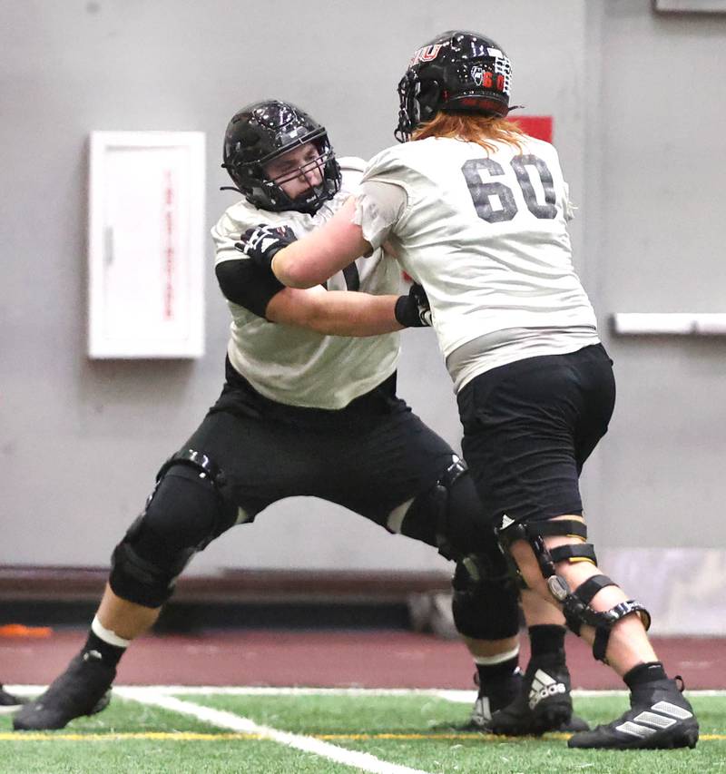 Northern Illinois offensive linemen Drew Hoth (left) and Evan Buss participate in a drill during the teams first spring practice Wednesday, March 22, 2023, in the Chessick Practice Center at Northern Illinois University in DeKalb.
