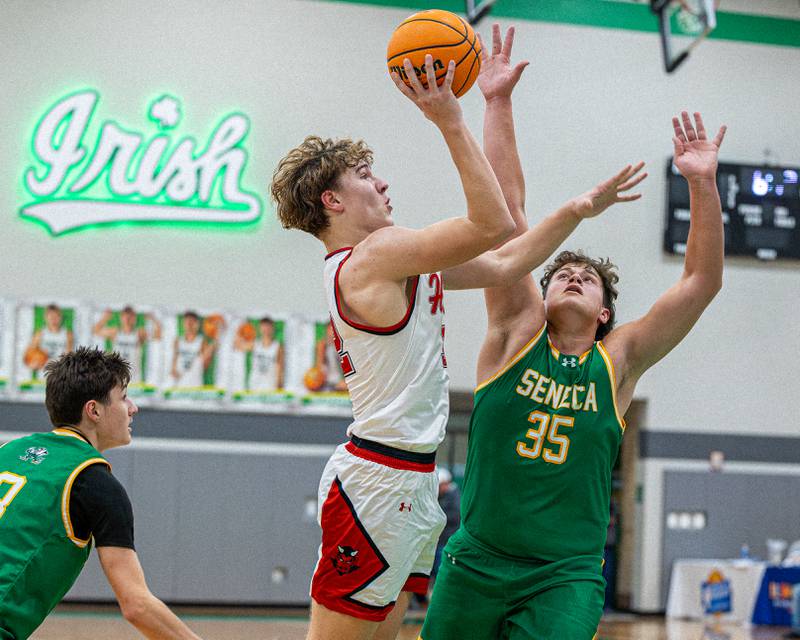 Chace Sterling (32) of Hall lays ball up as Zeb Maxwell (35) of Seneca jumps to block shot during game in the Shipyard Showdown on Tuesday, December 23, 2025 at Seneca High School in Seneca.