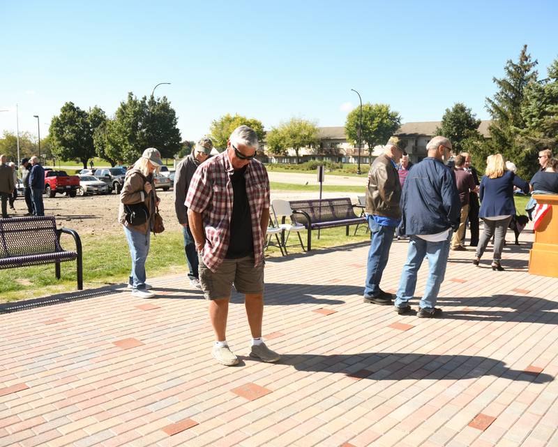 Bob Faivre looks at memorial bricks honoring area veterans that were placed at the base of the DeKalb Elks Veteran's Memorial Plaza, dedicated during a ceremony Saturday, Oct. 1, 2022.