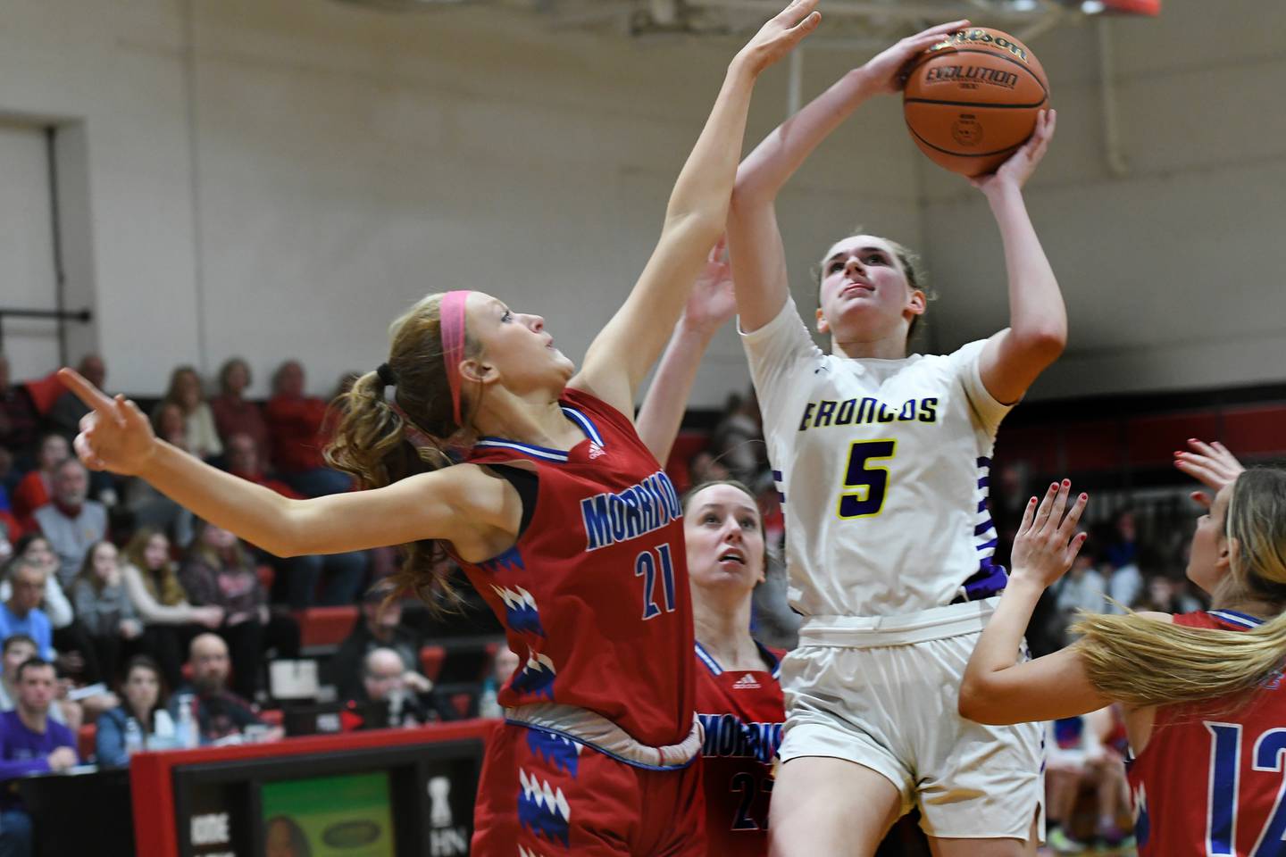 Morrison's Camryn Veltrop (21) tries to block a shot by Orangeville's Whitney Sullivan (5) during the championship of the 1A Pearl City Regional on Friday. The Broncos won the game 64-36 to advance to the Polo Sectional.
